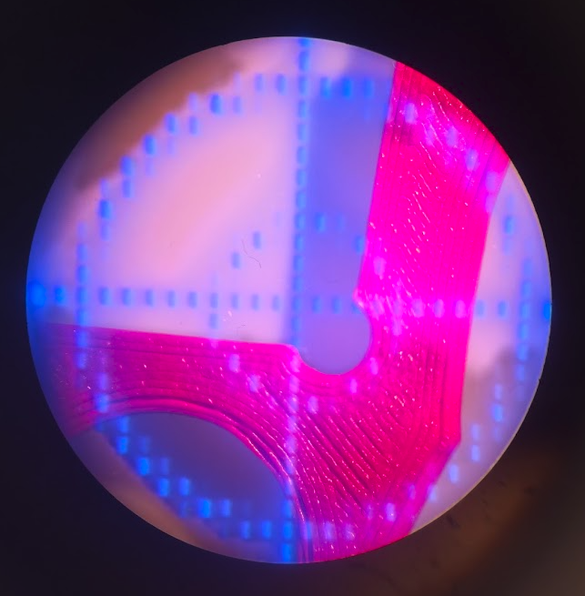 View through the eyepiece with a blue crosshair